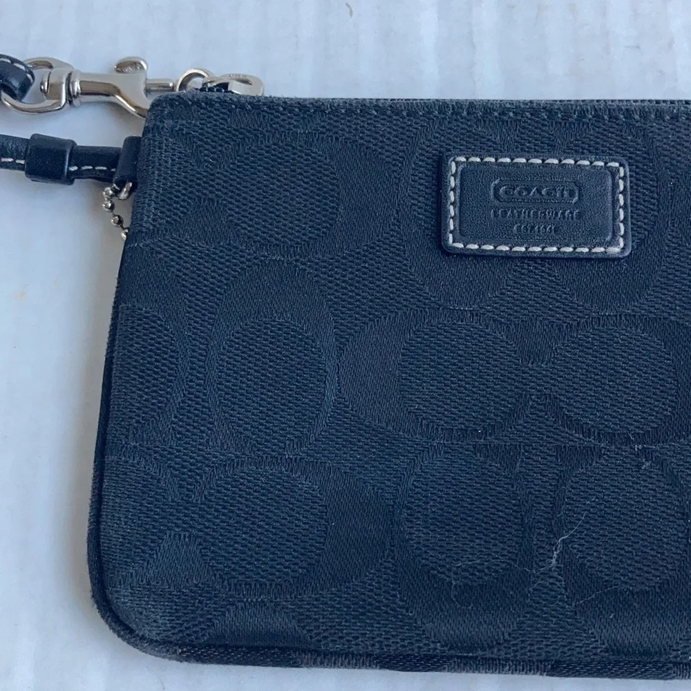 Coach black signature C mini wristlet.